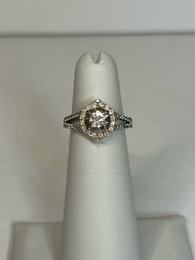 18k white and rose gold morganite ring with a hexagonal diamond halo on a display finger